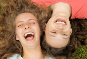 girls-laughing-in-grass-350